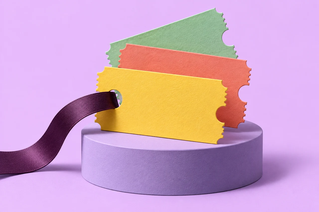 Three sculptural paper tickets with a dark ribbon